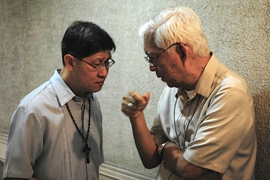 Manila Archbishop Luis Antonio Tagle discusses with Cardinal Gaudencio Rosales, his predecessor as archbishop of Manila in the sidelines of a plenary assembly of the Catholic Bishops Conference of the Philippines in Manila / Dave Viehland Photo published with permission.