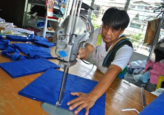 Master cutter in action at the Mandaluyong City branch of Talleres de Nazaret run by Siervas of San Jose nuns that was working to stay on schedule for school uniform production for school year 2014-2015 that starts in June. - NJ Viehland photos